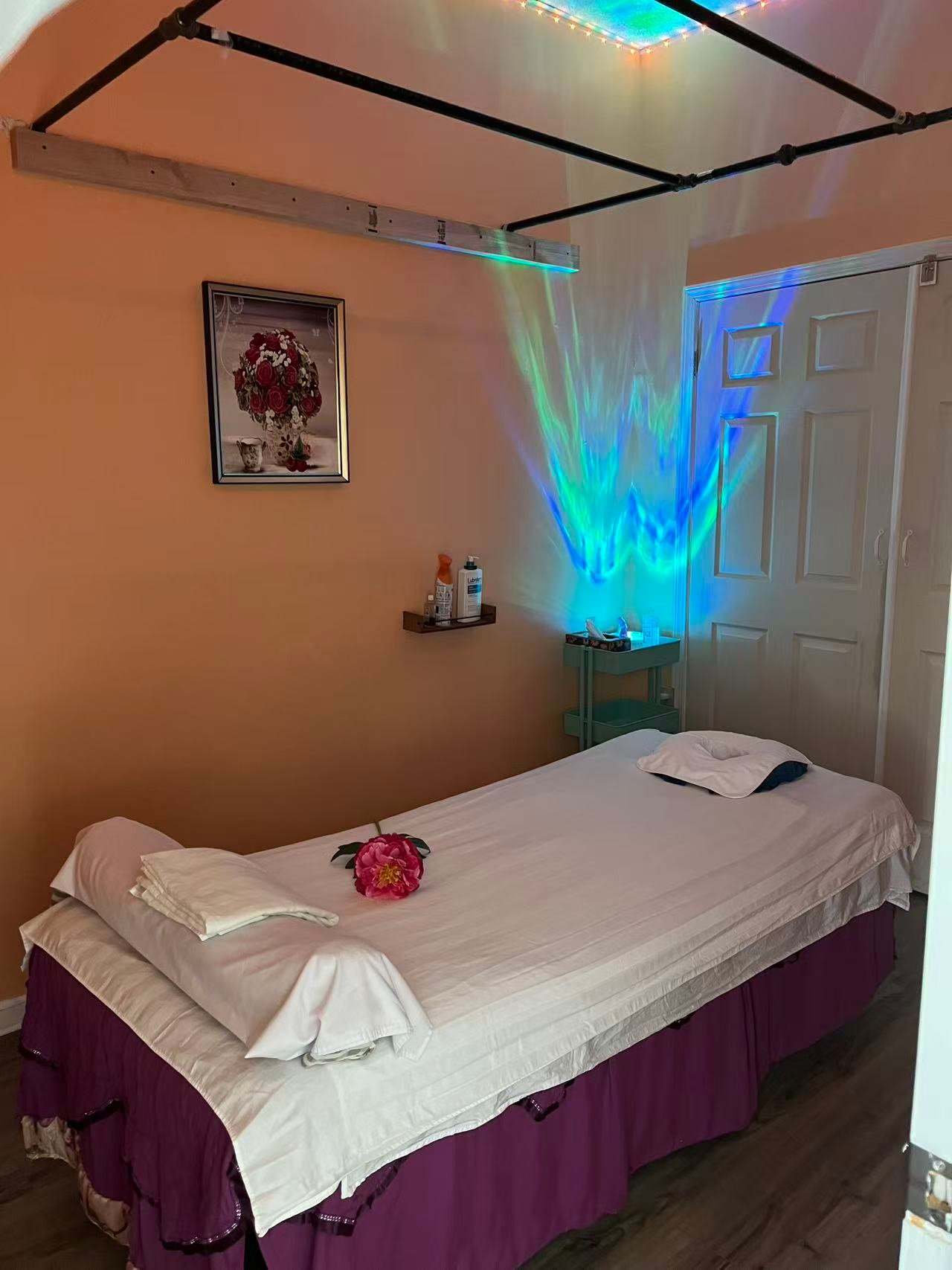 Ambient massage treatment room with calming colored light