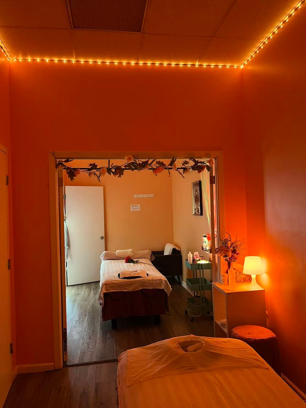 Connected massage treatment rooms with warm lighting